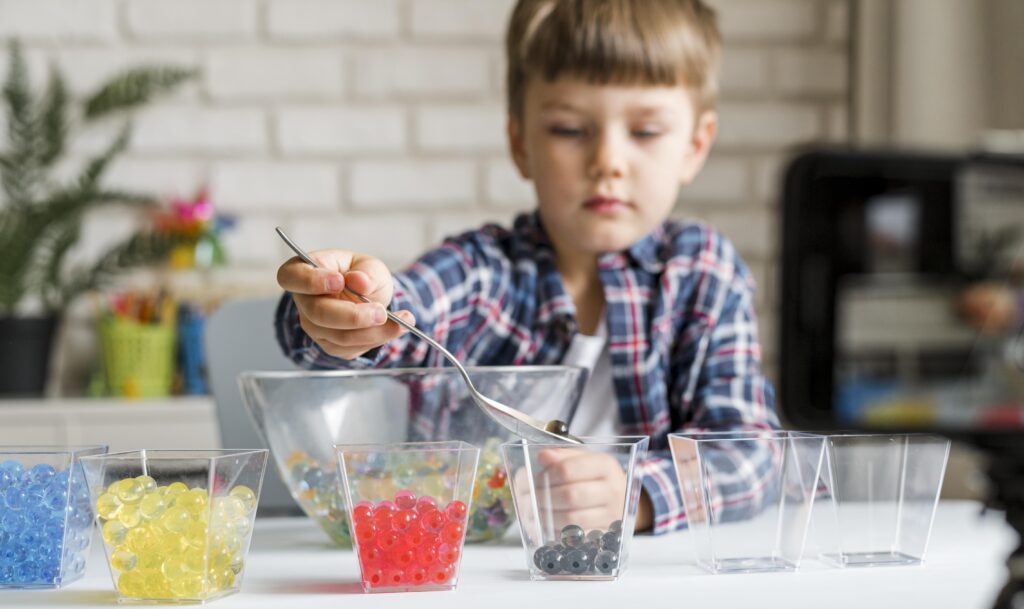 little kid with hydrogel balls